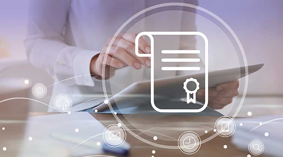 Online learning concept. Diploma with other icons on foreground and woman using tablet, closeup